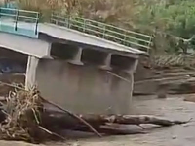 The center span of a bridge was taken out by flood waters as storms smashed Spain's Costa del Sol